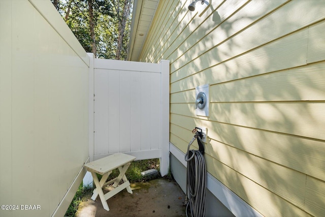 exterior details featuring wood walls and concrete floors