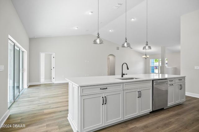 kitchen featuring pendant lighting, sink, an island with sink, and vaulted ceiling