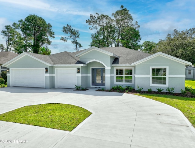 ranch-style house featuring a garage and a front yard