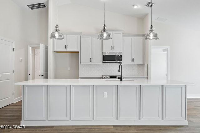 kitchen featuring white cabinets, hardwood / wood-style flooring, sink, and an island with sink