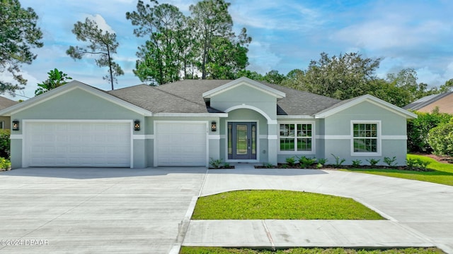 single story home with a garage and a front lawn