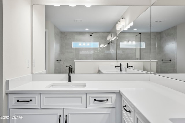 bathroom with vanity and a tile shower