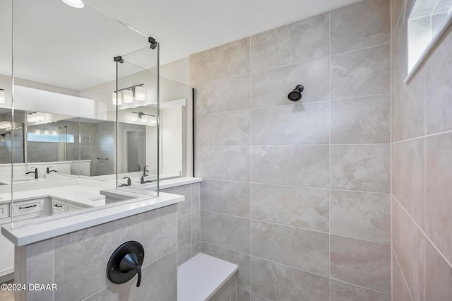 bathroom with vanity and tiled shower