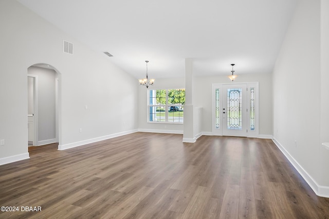 interior space with dark wood-type flooring and a notable chandelier