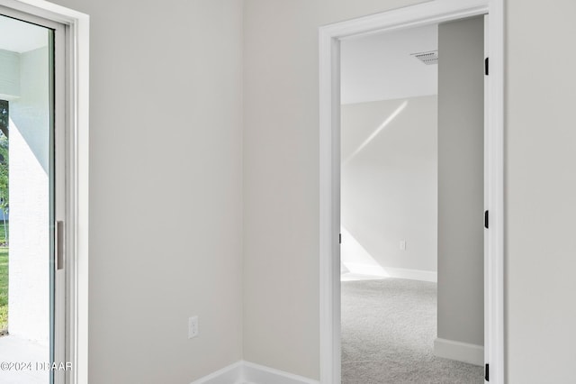 corridor featuring plenty of natural light and carpet floors