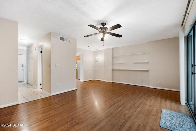 unfurnished living room featuring light hardwood / wood-style flooring and ceiling fan