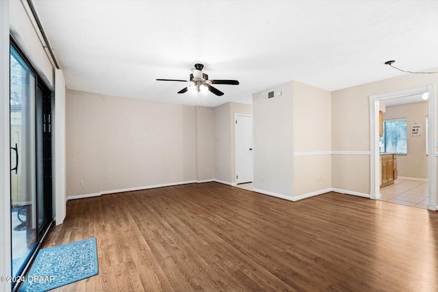 unfurnished room featuring ceiling fan, light hardwood / wood-style floors, and plenty of natural light