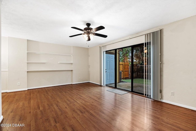 unfurnished living room featuring ceiling fan and hardwood / wood-style floors