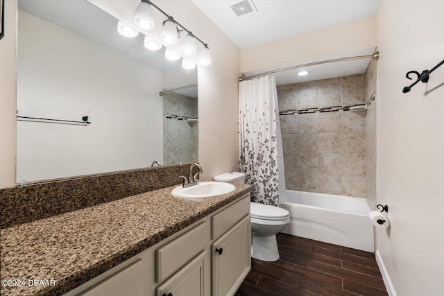 full bathroom with vanity, shower / bath combination with curtain, and toilet