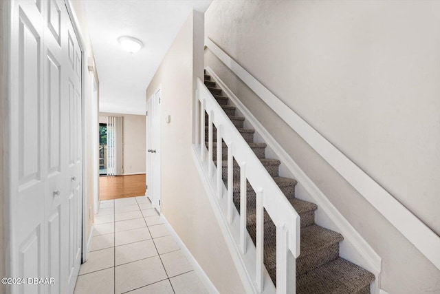 stairway with tile patterned flooring