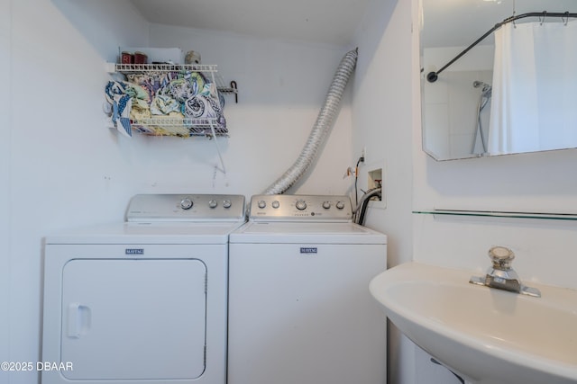 clothes washing area featuring sink and washer and dryer