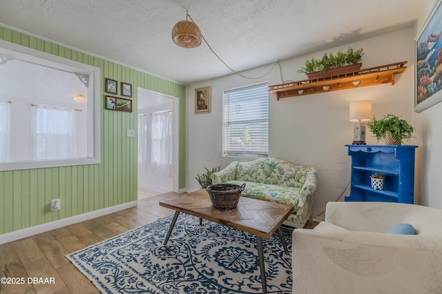 living room with a textured ceiling and light wood-type flooring