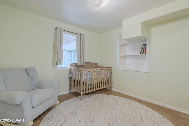 bedroom featuring light hardwood / wood-style flooring and a textured ceiling