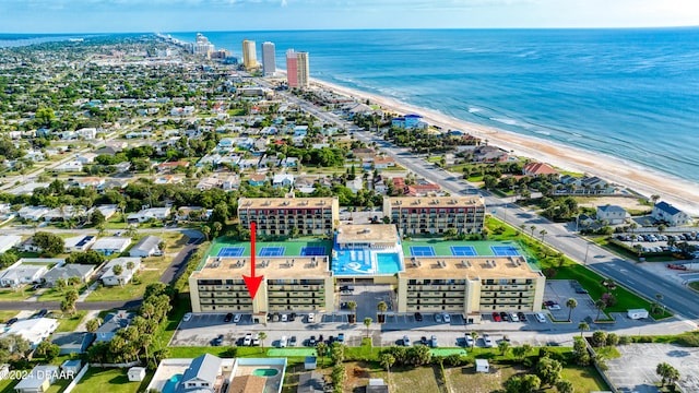 drone / aerial view featuring a beach view and a water view