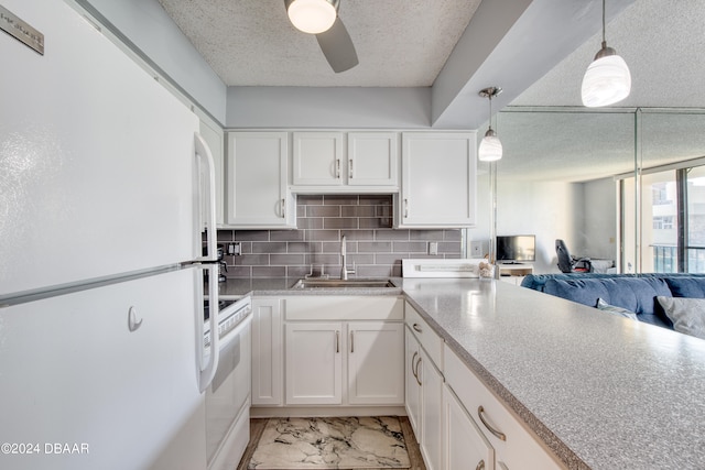 kitchen with white cabinetry, sink, white appliances, pendant lighting, and decorative backsplash