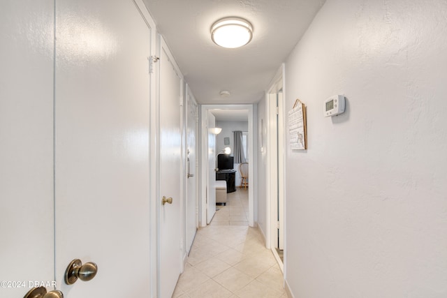 corridor with light tile patterned flooring