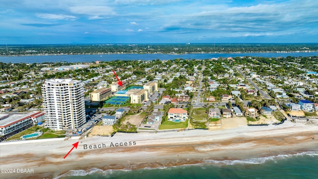 birds eye view of property featuring a beach view and a water view