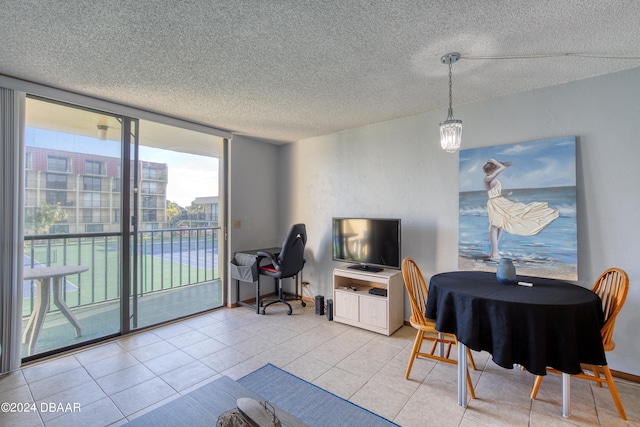 dining area featuring light tile patterned flooring and a textured ceiling