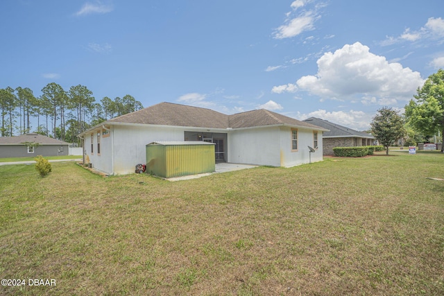 back of house with a yard