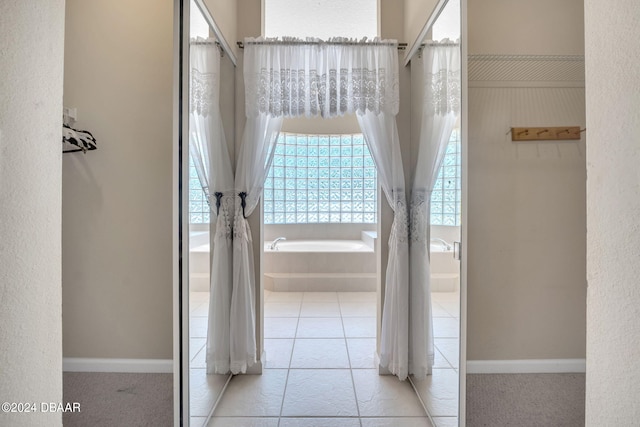 bathroom featuring tile patterned flooring and a bathtub