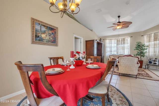 tiled dining room with ceiling fan with notable chandelier and lofted ceiling