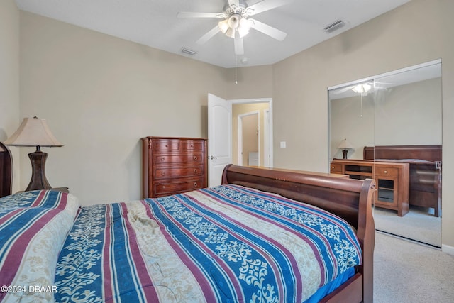 carpeted bedroom featuring ceiling fan and a closet