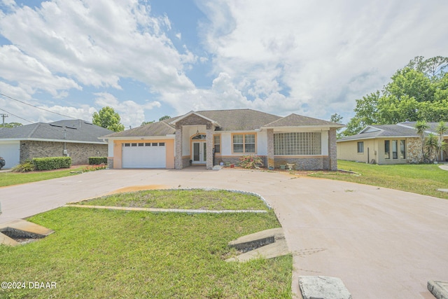 ranch-style home featuring a front yard and a garage