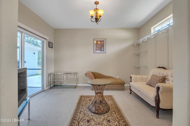 sitting room with carpet and a notable chandelier