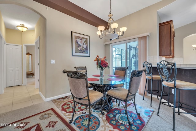 tiled dining area featuring a notable chandelier