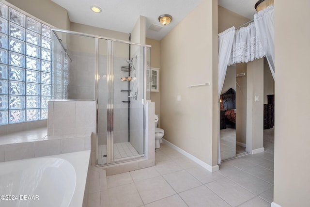 bathroom with tile patterned flooring, toilet, and shower with separate bathtub