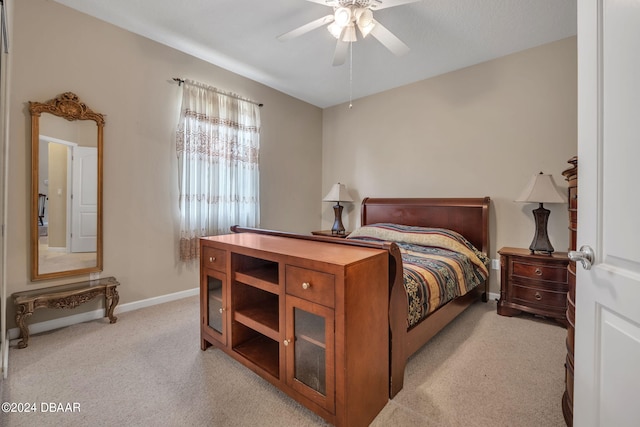 bedroom featuring light colored carpet and ceiling fan