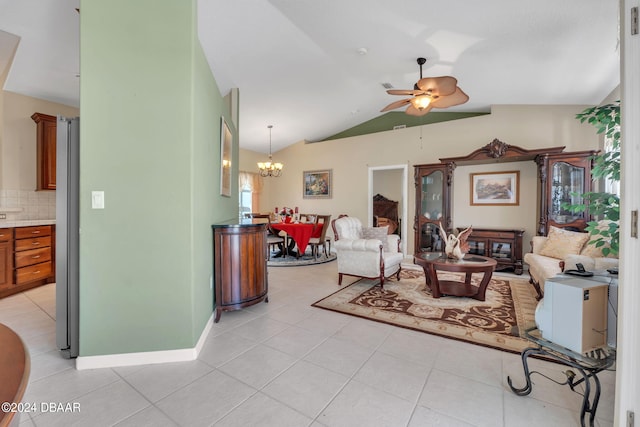 living room featuring ceiling fan with notable chandelier, light tile patterned floors, and lofted ceiling