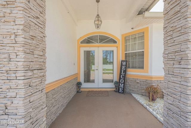 view of exterior entry featuring french doors