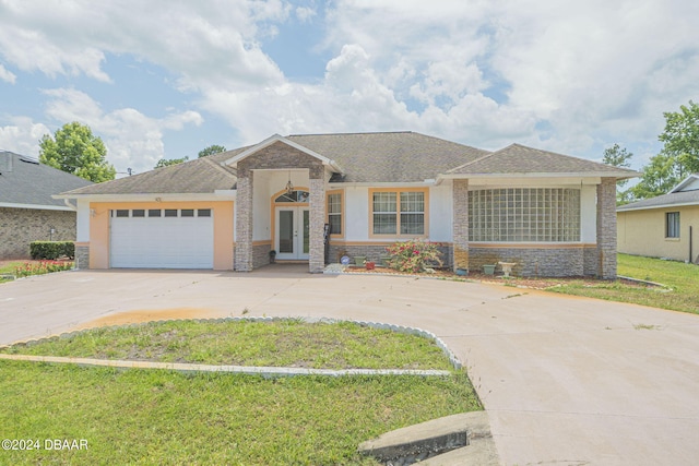 view of front of house with a front yard and a garage