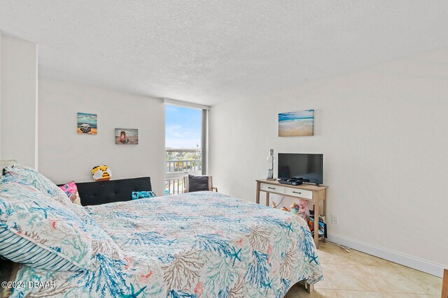 tiled bedroom with a textured ceiling