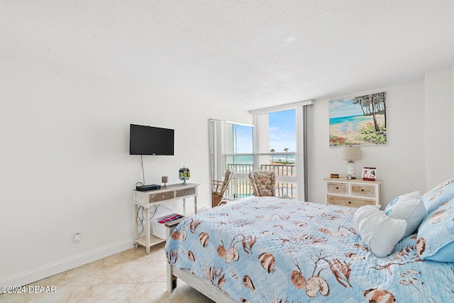 bedroom featuring a textured ceiling and light tile patterned floors