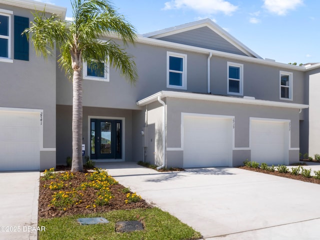 2718 Golden Trout Ln, Edgewater, FL 32141 - view of property featuring a garage, stucco siding, and driveway