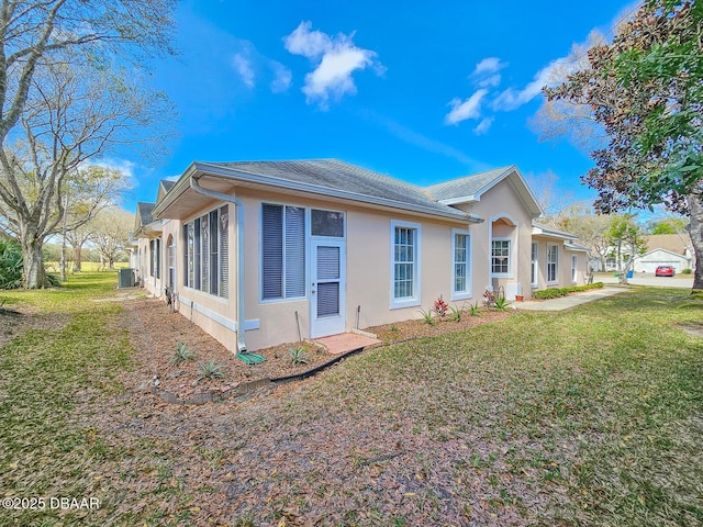 view of side of property with a lawn