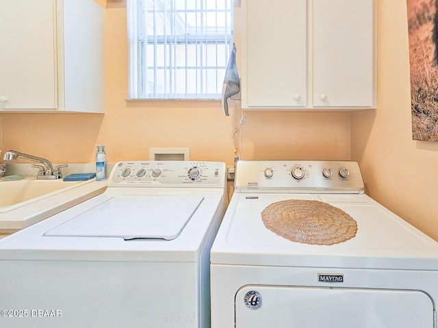 laundry room featuring cabinets, separate washer and dryer, and sink