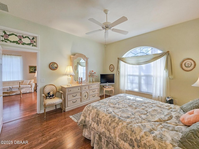 bedroom with dark hardwood / wood-style floors and ceiling fan