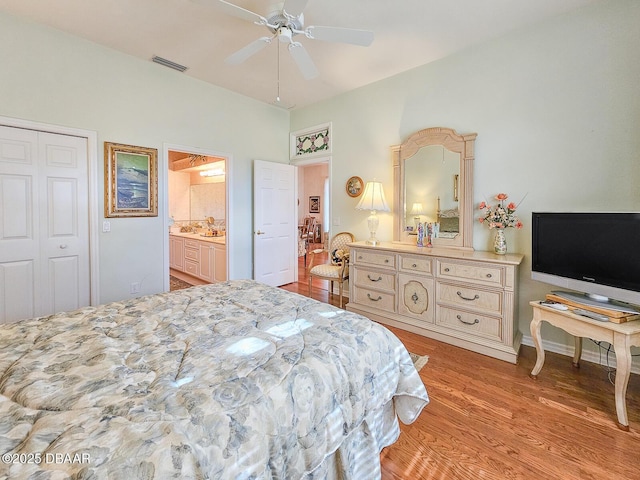 bedroom with ensuite bath, light hardwood / wood-style flooring, and ceiling fan