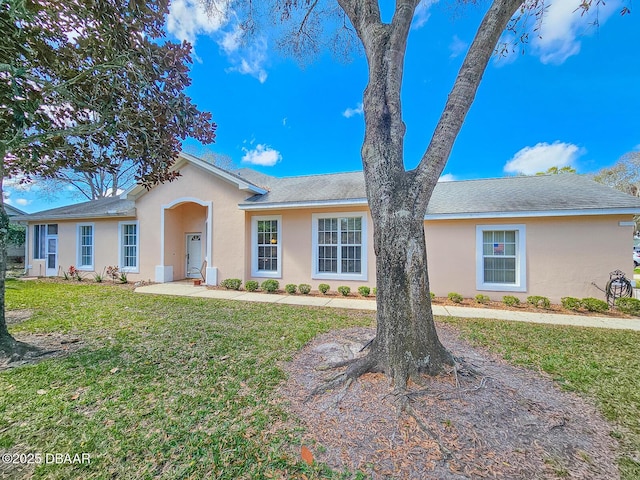 ranch-style home with a front lawn