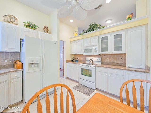 kitchen with white cabinetry, decorative backsplash, light tile patterned floors, ceiling fan, and white appliances