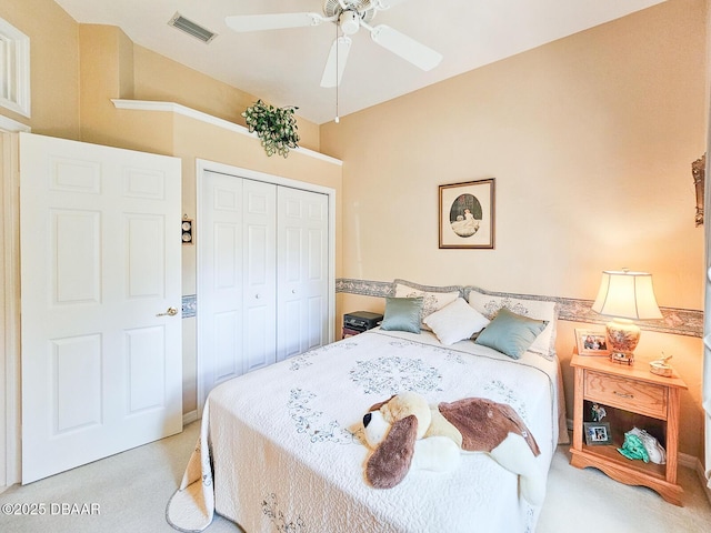 bedroom featuring light carpet, a closet, and ceiling fan