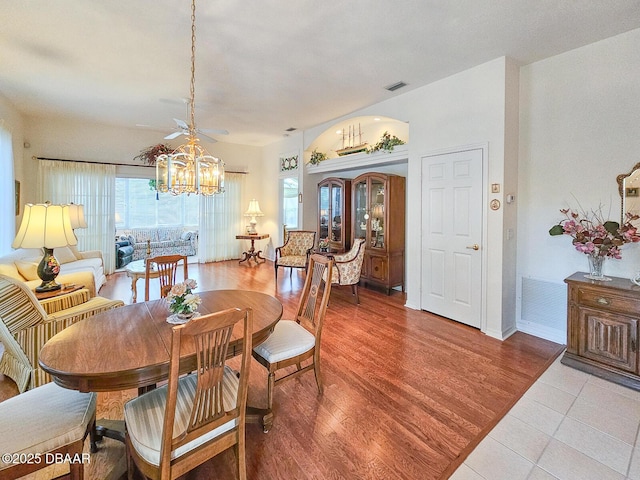 dining space featuring light hardwood / wood-style floors and a chandelier