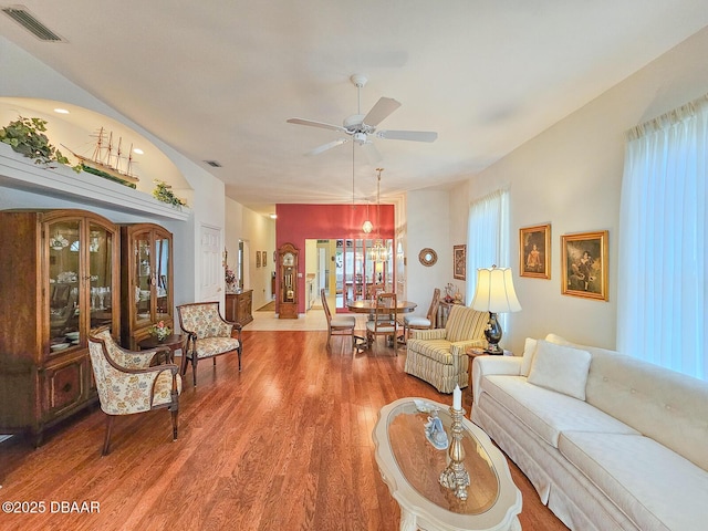 living room featuring wood-type flooring and ceiling fan