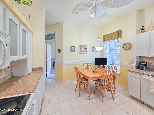 tiled dining room with ceiling fan