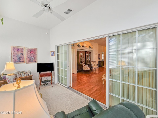 living room featuring hardwood / wood-style flooring and ceiling fan