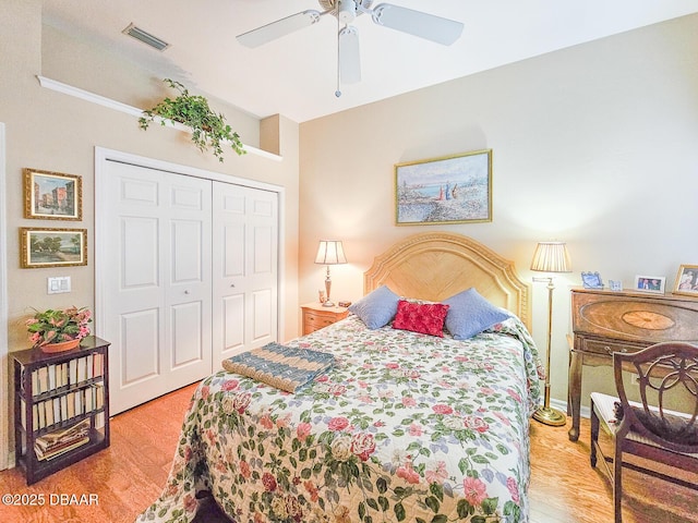 bedroom featuring ceiling fan, light hardwood / wood-style floors, and a closet