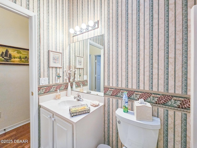 bathroom featuring vanity, toilet, and hardwood / wood-style floors